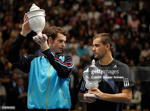 Andy Murray of Great Britain holds up the winners trophy as he chats with Mikhail Youzhny of Russia in the final of the ATP 500 World Tour Valencia...