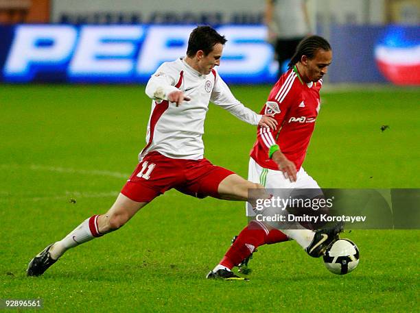 Peter Odemwingie of FC Lokomotiv Moscow is challenged by Aleksei Pomerko of FC Amkar Perm during the Russian Football League Championship match...