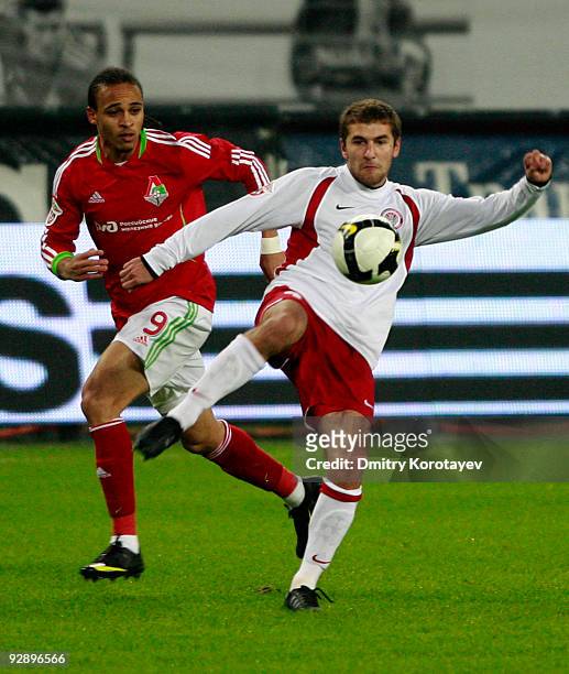 Peter Odemwingie of FC Lokomotiv Moscow is challenged by Vitaliy Fedoriv of FC Amkar Perm during the Russian Football League Championship match...