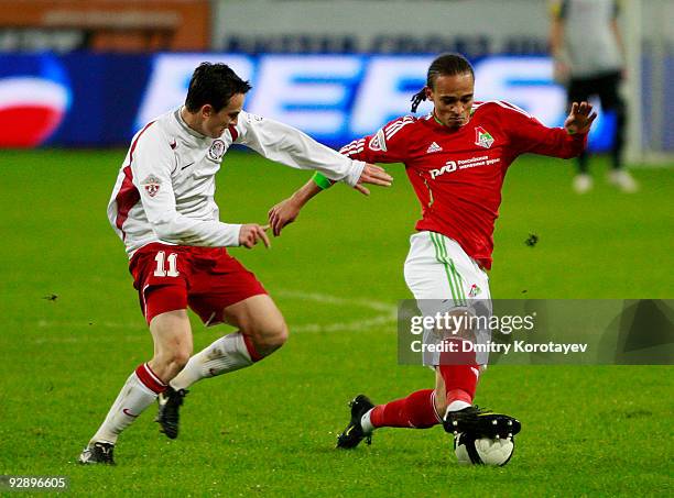 Peter Odemwingie of FC Lokomotiv Moscow is challenged by Aleksei Pomerko of FC Amkar Perm during the Russian Football League Championship match...