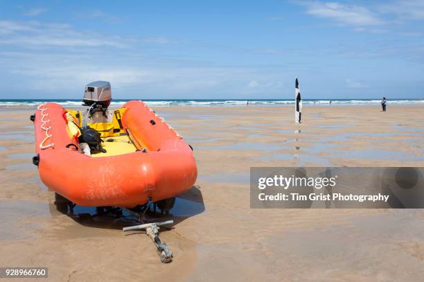 an orange rigid inflatable boat (rib) on a beach - boat engine stock pictures, royalty-free photos & images