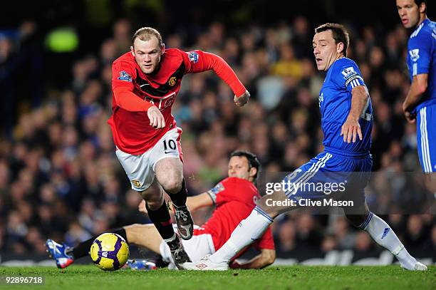 Wayne Rooney of Manchester United goes past the challenge from John Terry of Chelsea during the Barclays Premier League match between Chelsea and...