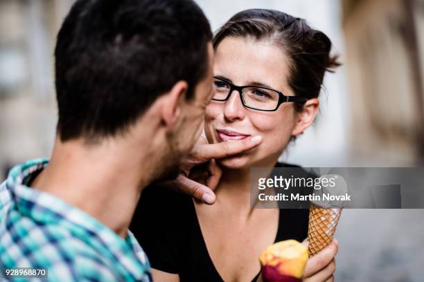girlfriend looking at man as he clean her mouth - man finger on lips stock pictures, royalty-free photos & images