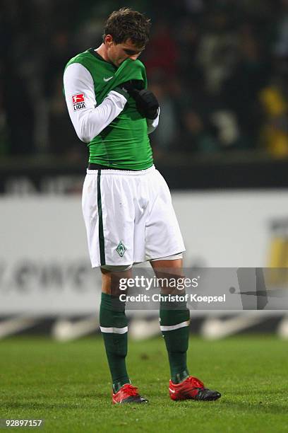 Sebastian Boenisch of Bremen looks dejected during the Bundesliga match between SV Werder Bremen and Borussia Dortmund at the Weser Stadium on...