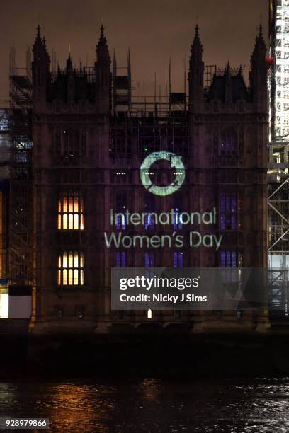 Messages are projected onto the Houses of Parliament to mark the start of International Women's Day on March 8, 2018 in London, England.