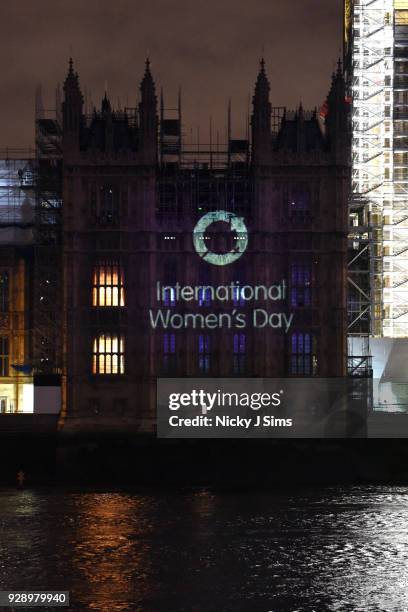 Messages are projected onto the Houses of Parliament to mark the start of International Women's Day on March 8, 2018 in London, England.