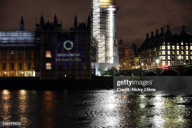 Messages are projected onto the Houses of Parliament to mark the start of International Women's Day on March 8, 2018 in London, England.