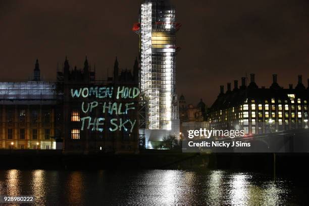 Messages are projected onto the Houses of Parliament to mark the start of International Women's Day on March 8, 2018 in London, England.