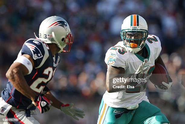 Ronnie Brown of the Miami Dolphins carries the ball as Leigh Bodden of the New England Patriots defends on November 8, 2009 at Gillette Stadium in...