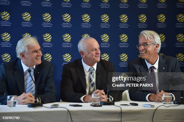 Sydney FC coach Graham Arnold smiles at a press conference with Football Federation Australia chairman Steven Lowy and Chief Executive Officer David...