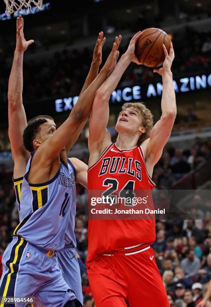 Lauri Markkanen of the Chicago Bulls shoots against Ivan Rabb of the Memphis Grizzlies at the United Center on March 7, 2018 in Chicago, Illinois....