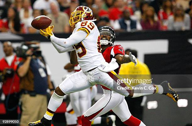 Santana Moss of the Washington Redskins attempts to pull in this reception against Chevis Jackson of the Atlanta Falcons at Georgia Dome on November...