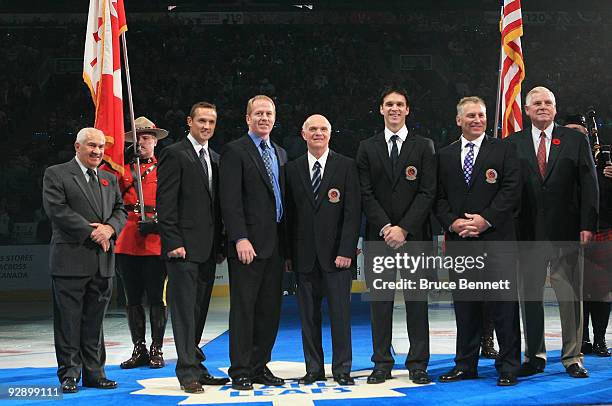 Surrounded by Jim Gregory and Bill Hay of the Hall of Fame, Steve Yzerman, Brian Leetch, Lou Lamoriello, Luc Robitaille, and Brett Hull receive their...