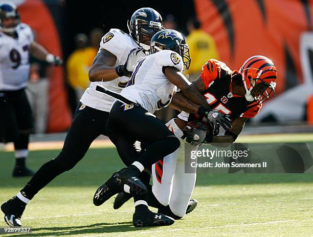 Wide receiver Chris Henry of the Cincinnati Bengals is tackled by Lardarius Webb of the Baltimore Ravens in their NFL game at Paul Brown Stadium...