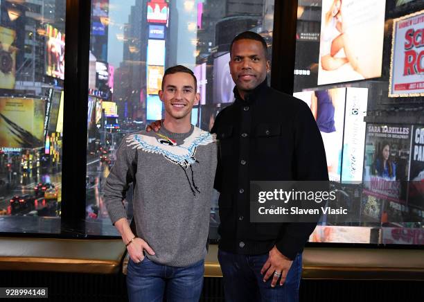 Winter Olympics bronze in the team event, figure skater Adam Rippon and Extra's NYC host AJ Calloway pose for photo at "Extra" at Renaissance New...