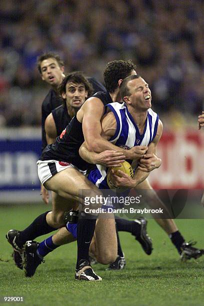 John Blakey for the Kangaroo's, is tackled by Brendan Fevola for Carlton, in the match between the Kangaroos and the Carlton Blues, during round nine...