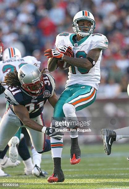 Brandon Meriweather of the New England Patriots attempts to stop Ted Ginn of the Miami Dolphins gives chase at Gillette Stadium on November 8, 2009...