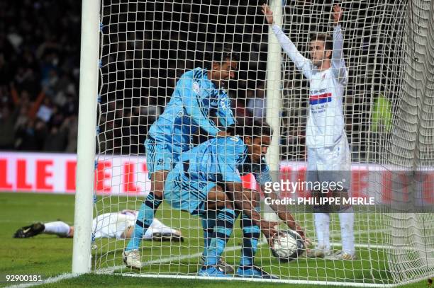 Marseille midfielder Fabrice Abriel and Brazilian forward Brandao celebrates after Lyon's midfielder Jeremy Toulalan scored an own goal at the end of...