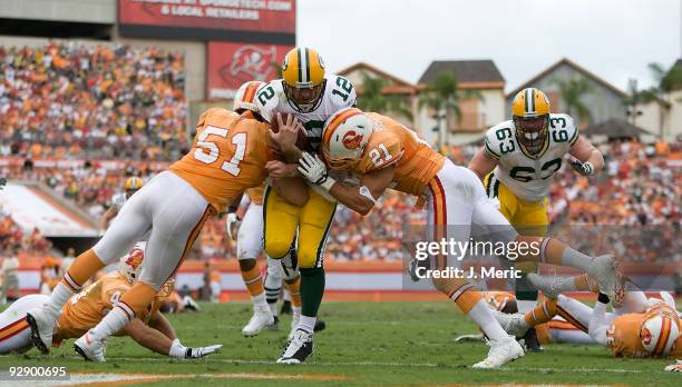 Quarterback Aaron Rodgers of the Green Bay Packers scores a fourth quarter touchdown as defenders Barrett Ruud and Sabby Piscatelli of the Tampa Bay...