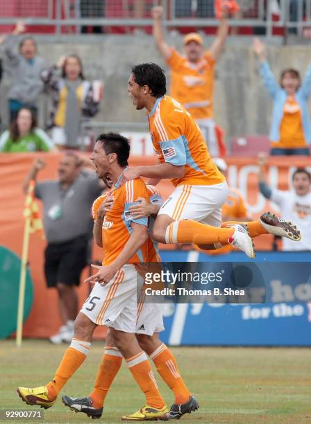 Brian Ching celebrates with Luis Angel Landin of the Houston Dynamo after scoring in the 5th minute of the first overtime period against the Seattle...