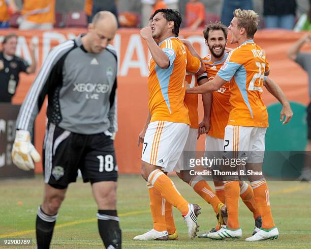 Brian Ching celebrates with Luis Angel Landin of the Houston Dynamo after scoring in the 5th minute of the first overtime period against goalie Kasey...