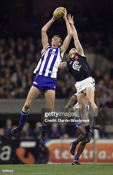 Matthew Burton for the Kangaroo's, marks over his Carlton opponant, in the match between the Kangaroos and the Carlton Blues, during round nine of...