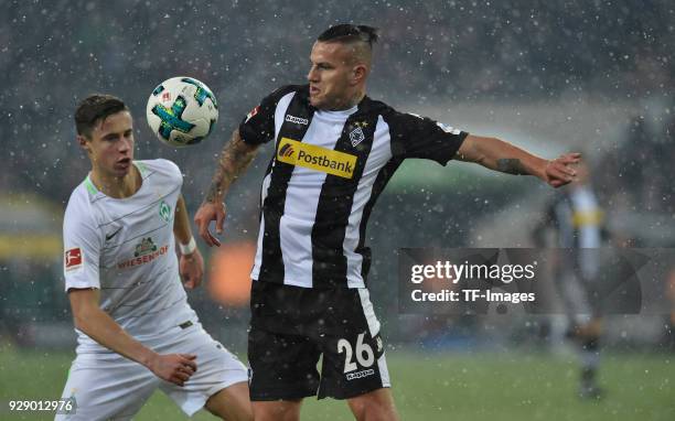 Marco Friedl of Bremen and Raul Bobadilla of Moenchengladbach battle for the ball during the Bundesliga match between Borussia Moenchengladbach and...