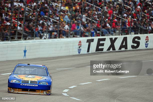 Kurt Busch, driver of the Miller Lite Dodge, races during the NASCAR Sprint Cup Series Dickies 500 at Texas Motor Speedway on November 8, 2009 in...