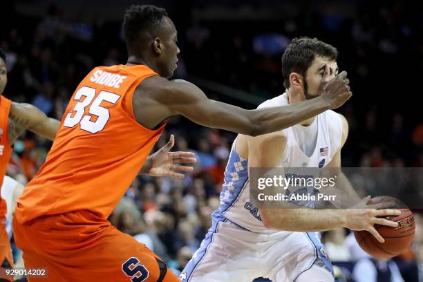 Bourama Sidibe of the Syracuse Orange defends against Luke Maye of the North Carolina Tar Heels in the second half during the second round of the ACC...