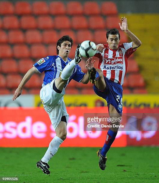 Juan Forlin of Espanyol stretches for a incoming ball against Miguel De Las Cuevas of Sporting Gijon durinig the La Liga match between Espanyol and...