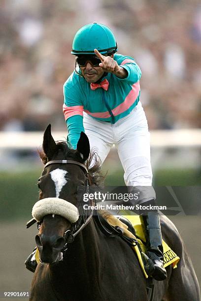 Jockey Mike Smith celebrates as he crosses the finish line to win the Breeders' Cup Classic race on Zenyatta during the Breeders' Cup World...