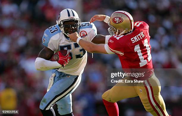 Alex Smith of the San Francisco 49ers tries to tackle Keith Bulluck of the Tennessee Titans after Bulluck recovered a fumble by Smith at Candlestick...