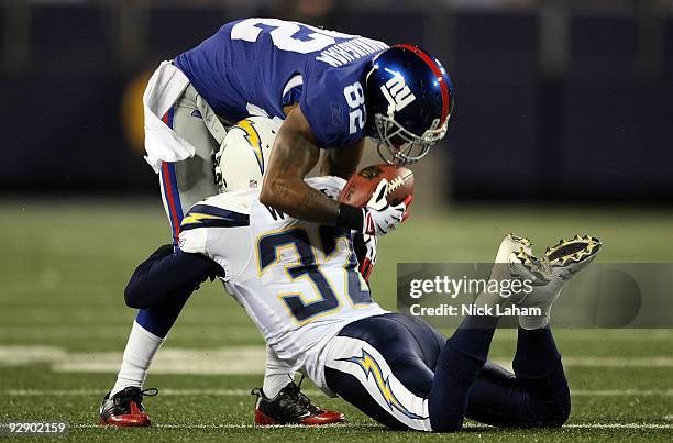 Mario Manningham of the New York Giants is tackled by Eric Weddle of the San Diego Chargers at Giants Stadium on November 8, 2009 in East Rutherford,...