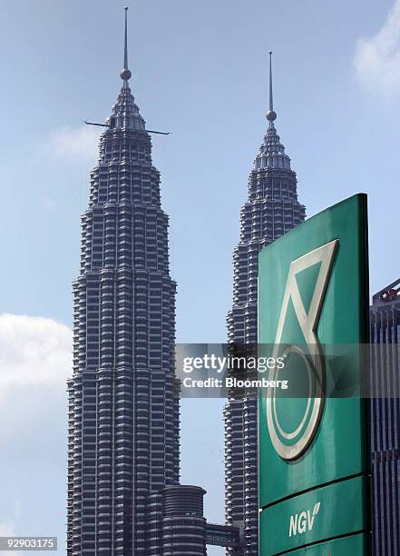 Signboard for a Petroliam Nasional Bhd. Gas station stands near the Petronas KLCC Twin Towers in Kuala Lumpur, Malaysia, on Saturday, Nov. 7, 2009....