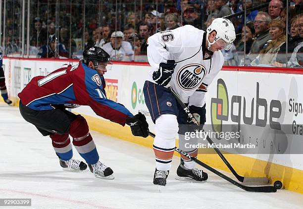 Cody McCormick of the Colorado Avalanche skates against Ryan Potulny of the Edmonton Oilers at the Pepsi Center on November 8, 2009 in Denver,...