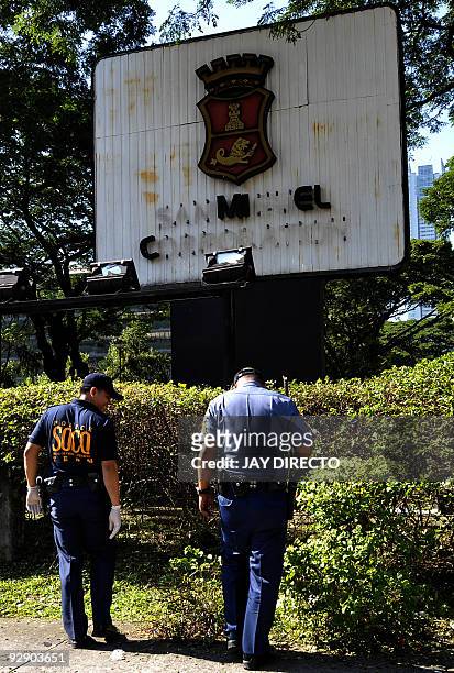 Police ordnance experts gather evidence at the damaged signage at the headquarters of brewer San Miguel Corp. In Mandaluyong City on November 9,...