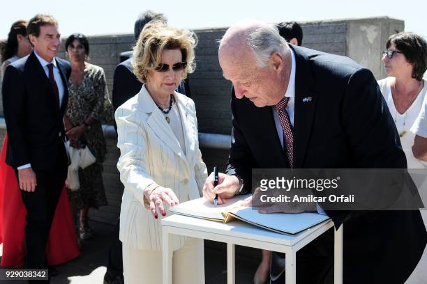 King Harald V of Norway signs the visitor's book next to Queen Sonja of Norway during a visit to 'Parque de la Memoria' as part of an official visit...