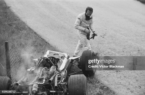 Italian-Belgian racing driver Lucien Bianchi leaving his vehicle, #14 Cooper-BRM T86B, after having an accident after 9 laps at the Dutch Grand Prix,...