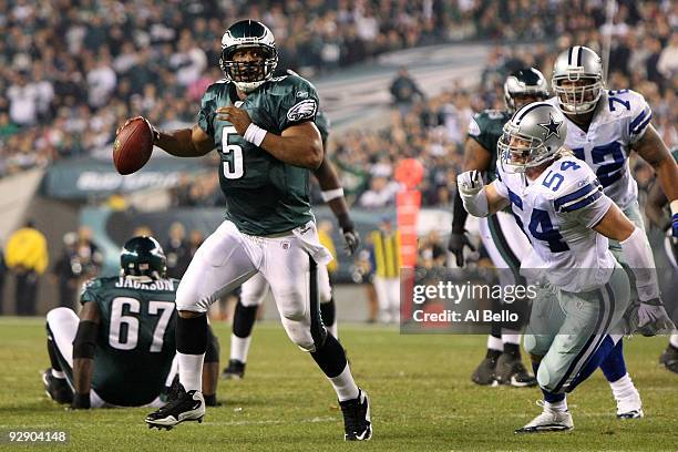 Donovan McNabb of the Philadelphia Eagles rolls out to throw an 11-yard touchdown pass to Brent Celek in the third quarter against Bobby Carpenter of...