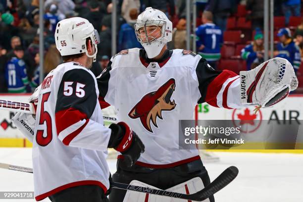 Darcy Kuemper of the Arizona Coyotes celebrates with teammate Jason Demers after winning their NHL game at Rogers Arena March 7, 2018 in Vancouver,...