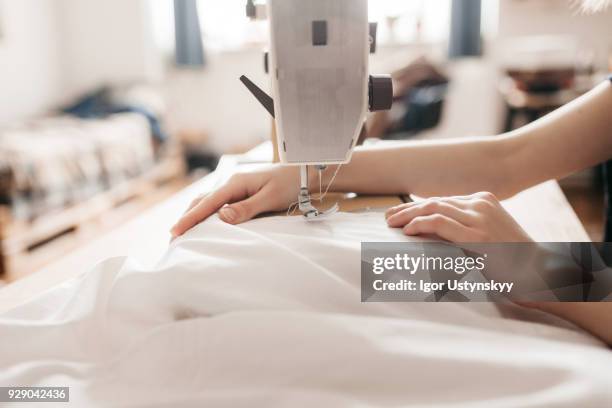 close-up of fashion designer threading sewing machine - sewing machine stock pictures, royalty-free photos & images