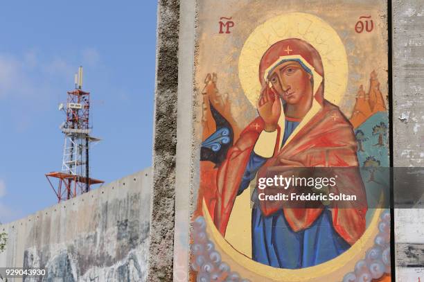 Political and social mural painting and graffitis illustrating the Virgin Mary by a Russian painter of icons on the Israeli West Bank barrier in...