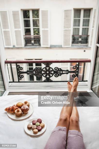 woman having breakfast in bed in paris - french croissant stock pictures, royalty-free photos & images
