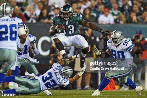 Fullback Leonard Weaver of the Philadelphia Eagles jumps over cornerback Orlando Scandrick of the Dallas Cowboys on November 8, 2009 at Lincoln...