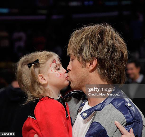 Larry Birkhead and his daughter Dannielynn Birkhead kiss at a game between the New Orleans Hornets and the Los Angeles Lakers at Staples Center on...
