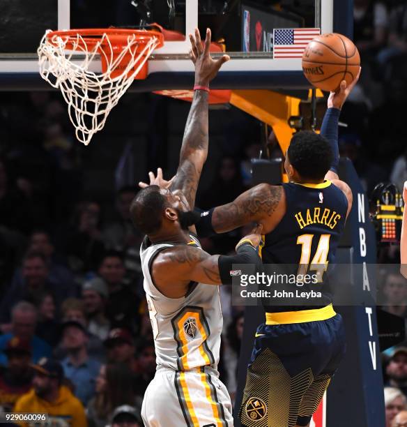 Denver Nuggets guard Gary Harris drives past Cleveland Cavaliers forward LeBron James in the third quarter on March 7, 2018 at Pepsi Center.