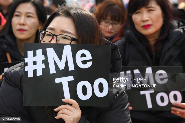 South Korean demonstrators hold banners during a rally to mark International Women's Day as part of the country's #MeToo movement in Seoul on March...
