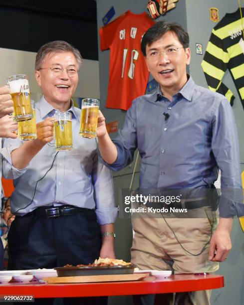 Photo taken in April 2017 shows then South Chungcheong Province Gov. An Hee Jung and presidential candidate Moon Jae In raising a toast as a...