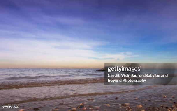 soft waves, pastel colors and a rock - huntington new york stockfoto's en -beelden