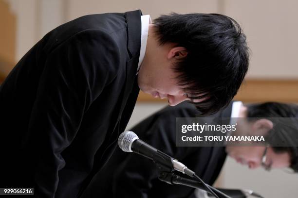 Koichiro Wada , president of Japan's virtual currency exchange Coincheck, and board member Yusuke Otsuka bow at the beginning of a press conference...